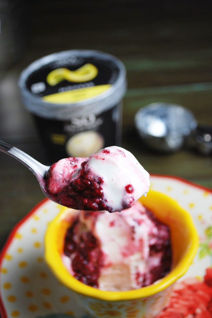 A close up of a spoonful of mousse with compote on top