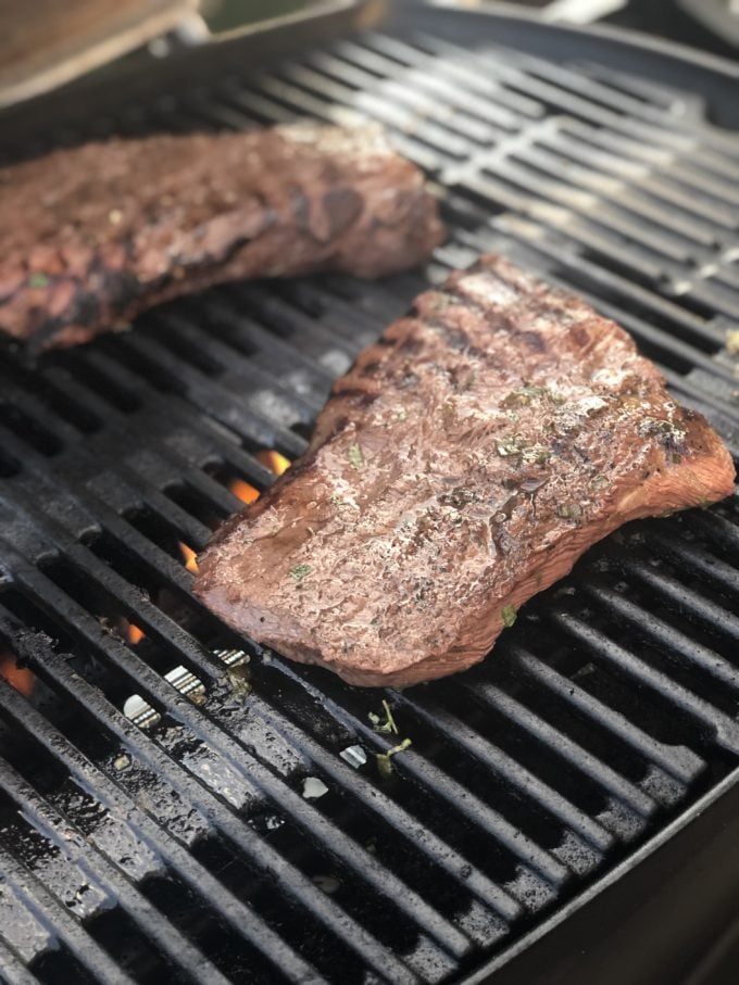 A close up of flat iron steak on a grill