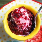 bowl of frozen yogurt with raspberry compote on top