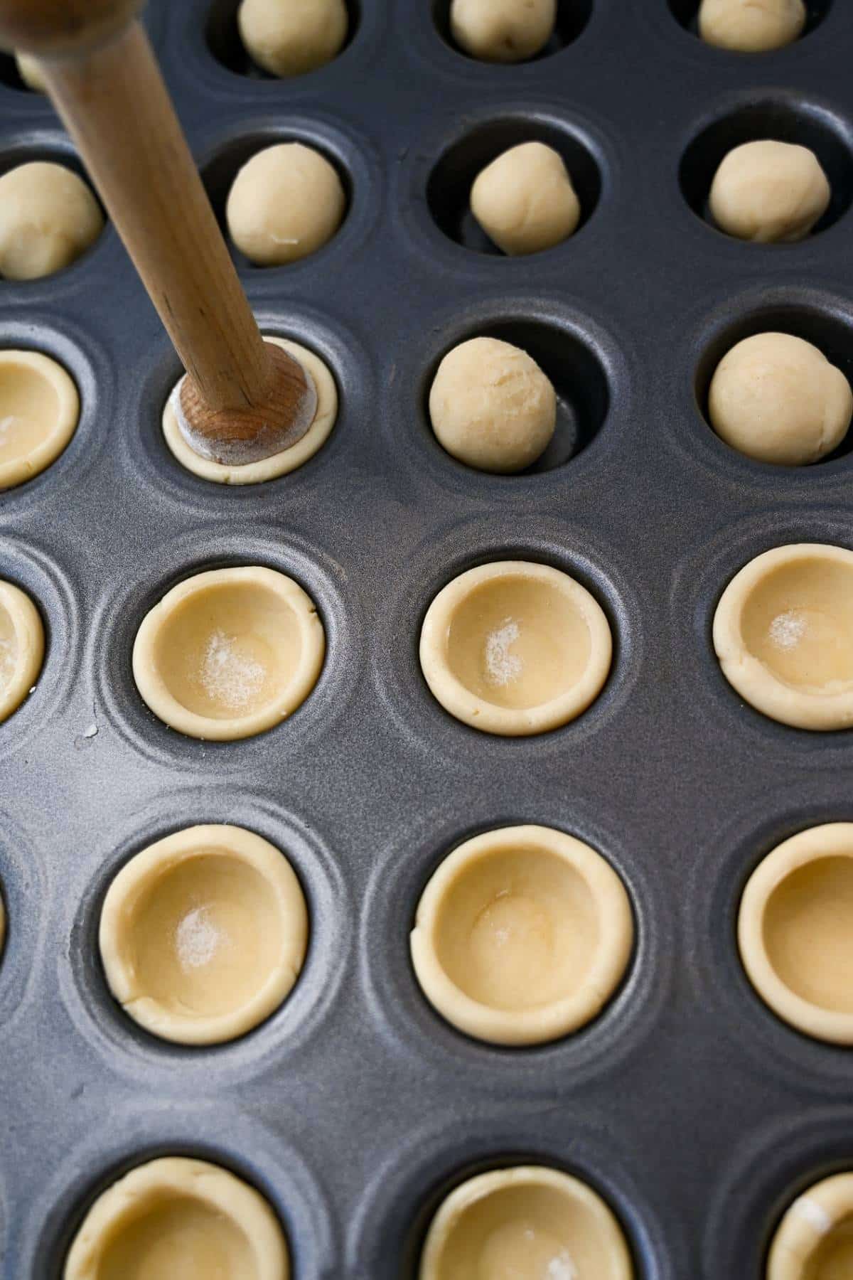 shaping a tart cookie shell with a tart tamper 