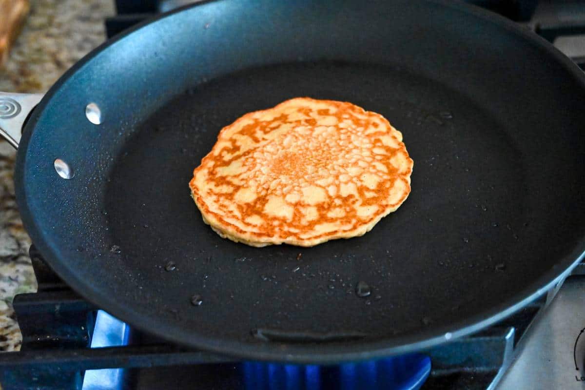 a pancake cooking in a skillet