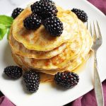 Protein blender pancakes on a plate with fresh blackberries and a fork