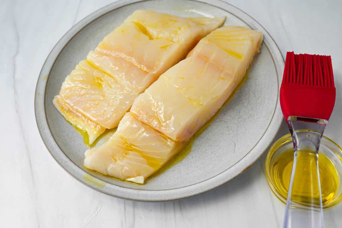 two halibut fillets brushed with olive oil