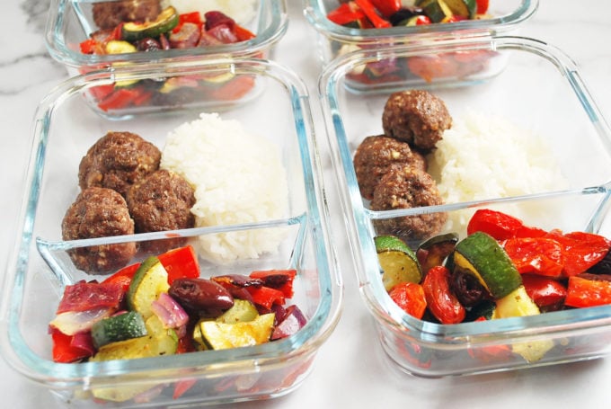 Greek meatballs, rice, and vegetables in glass meal prep containers