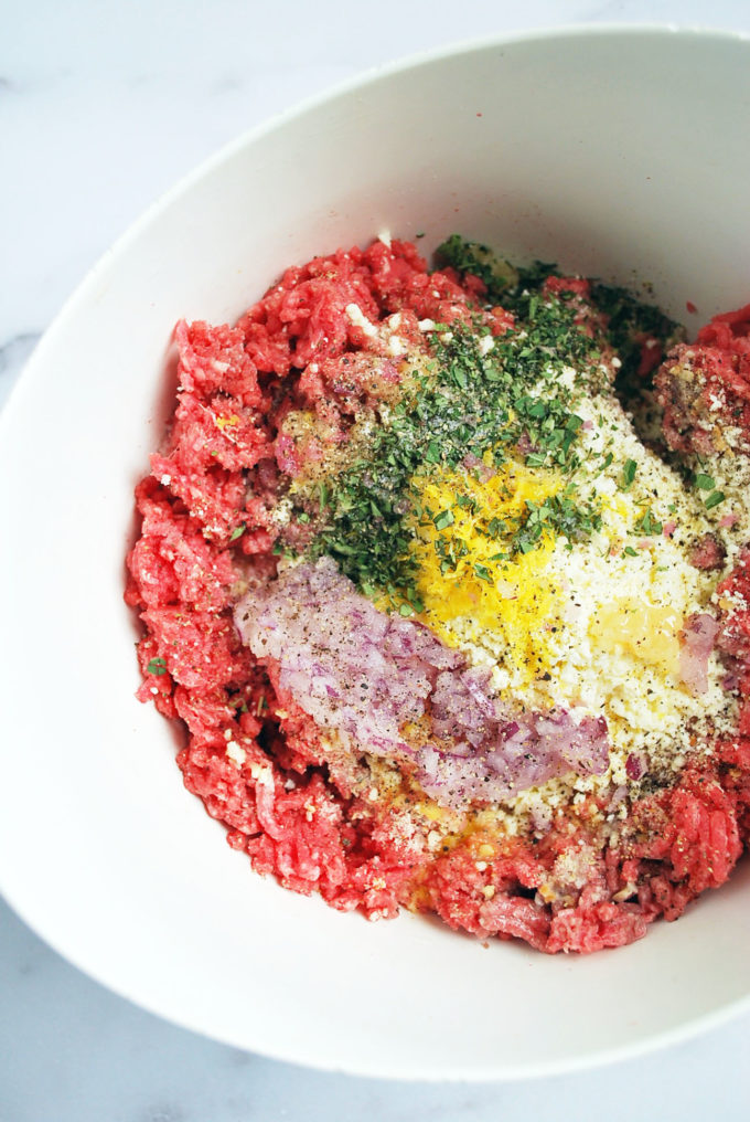 Greek meatball ingredients in a bowl ready to be mixed