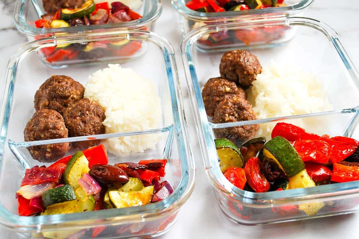 meatballs, vegetables and rice in four meal prep containers