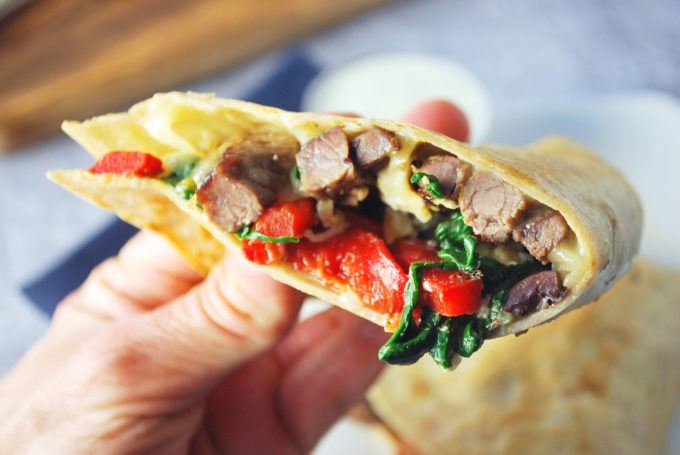 A close up of the inside of a steak quesadilla