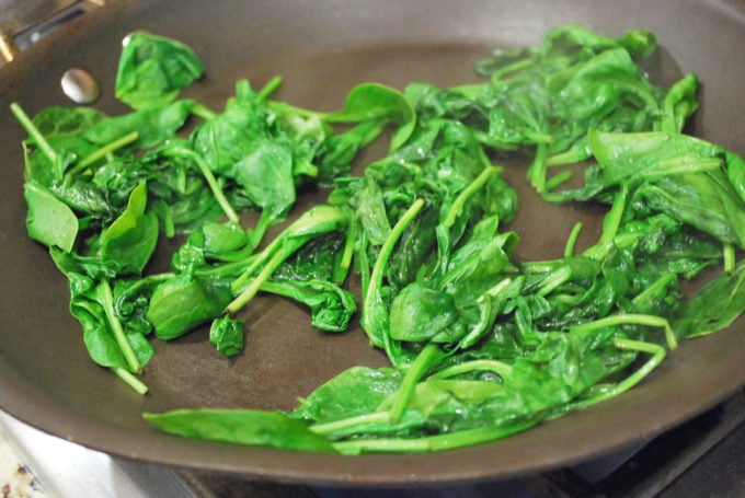 Wilted spinach in a skillet for quesadillas
