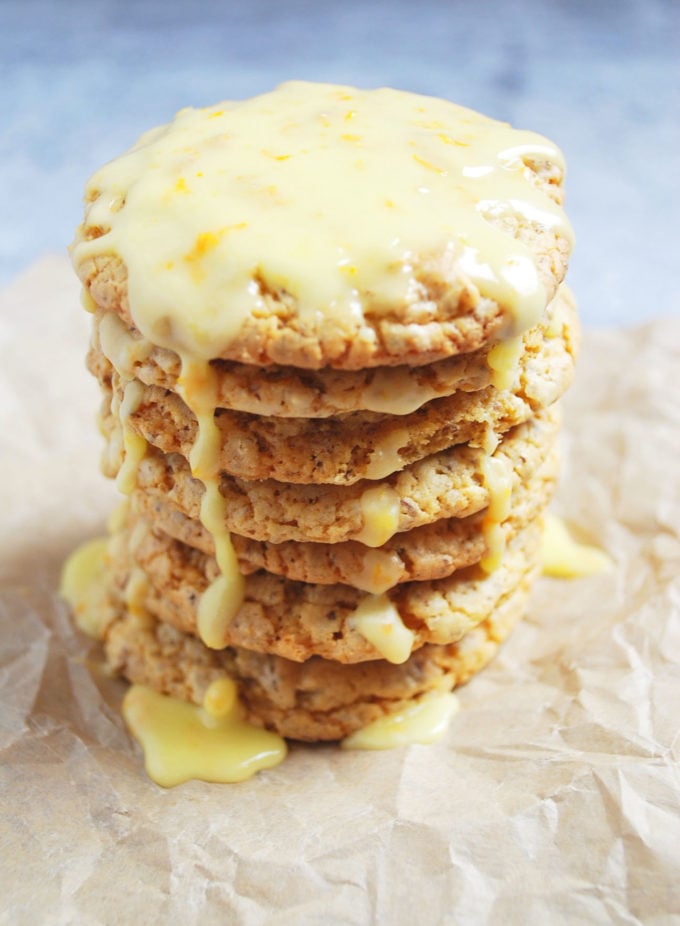 stack of orange cake mix cookies dripping with icing