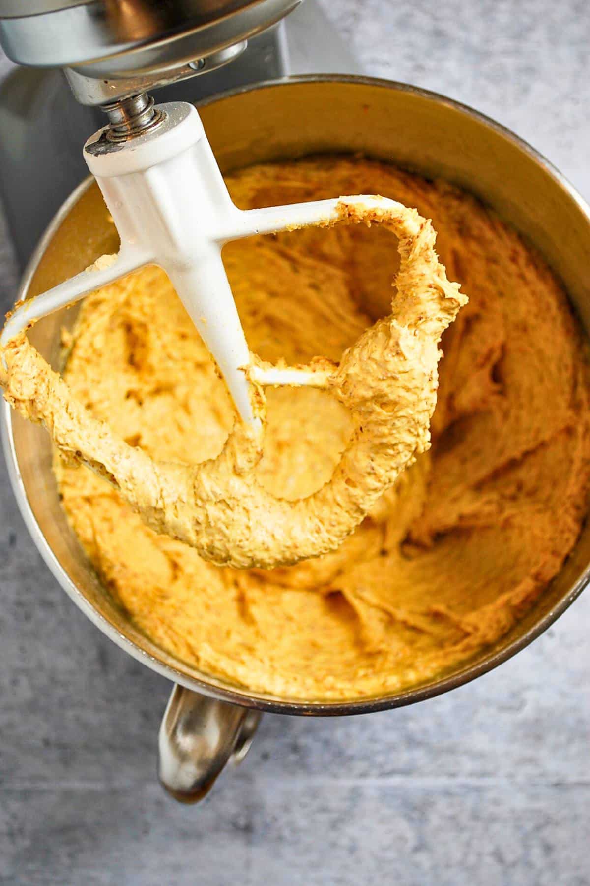 orange cake mix cookie batter in a stand mixer