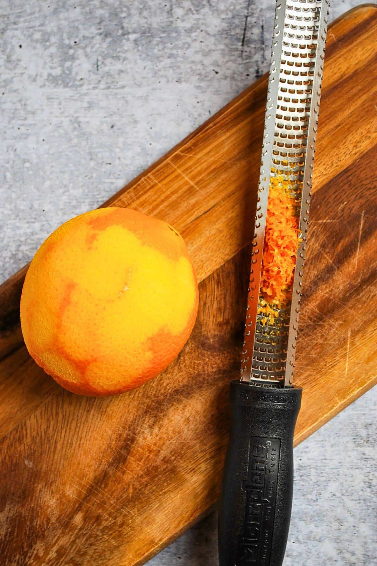 a microplane zester with a zested orange