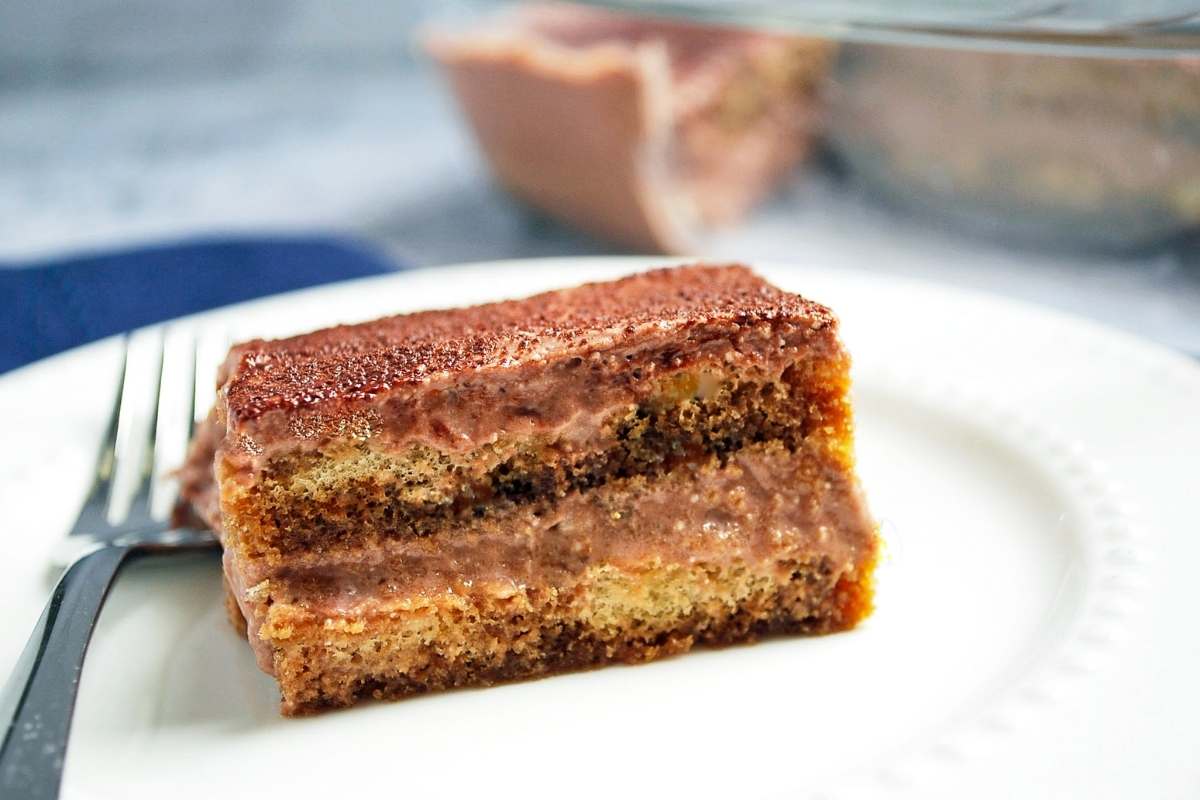 a slice of chocolate protein tiramisu on a plate with a fork