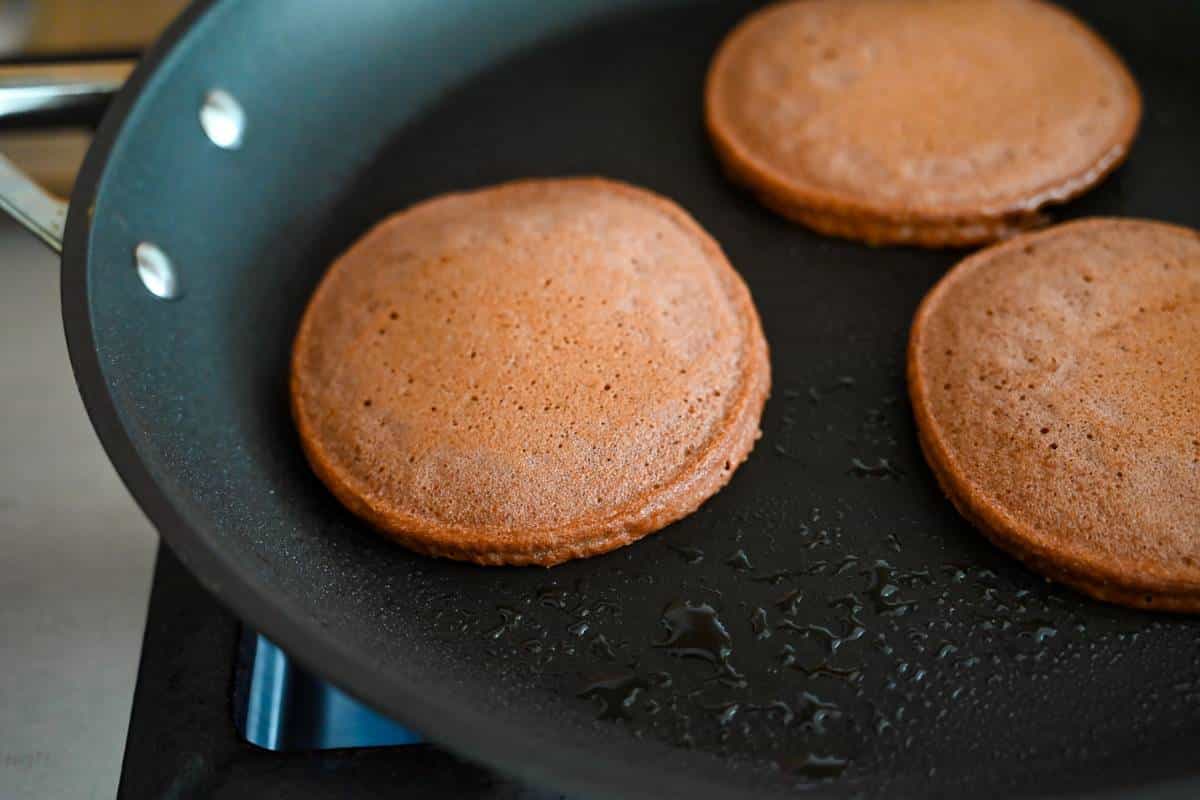 chocolate protein pancakes cooked in a skillet