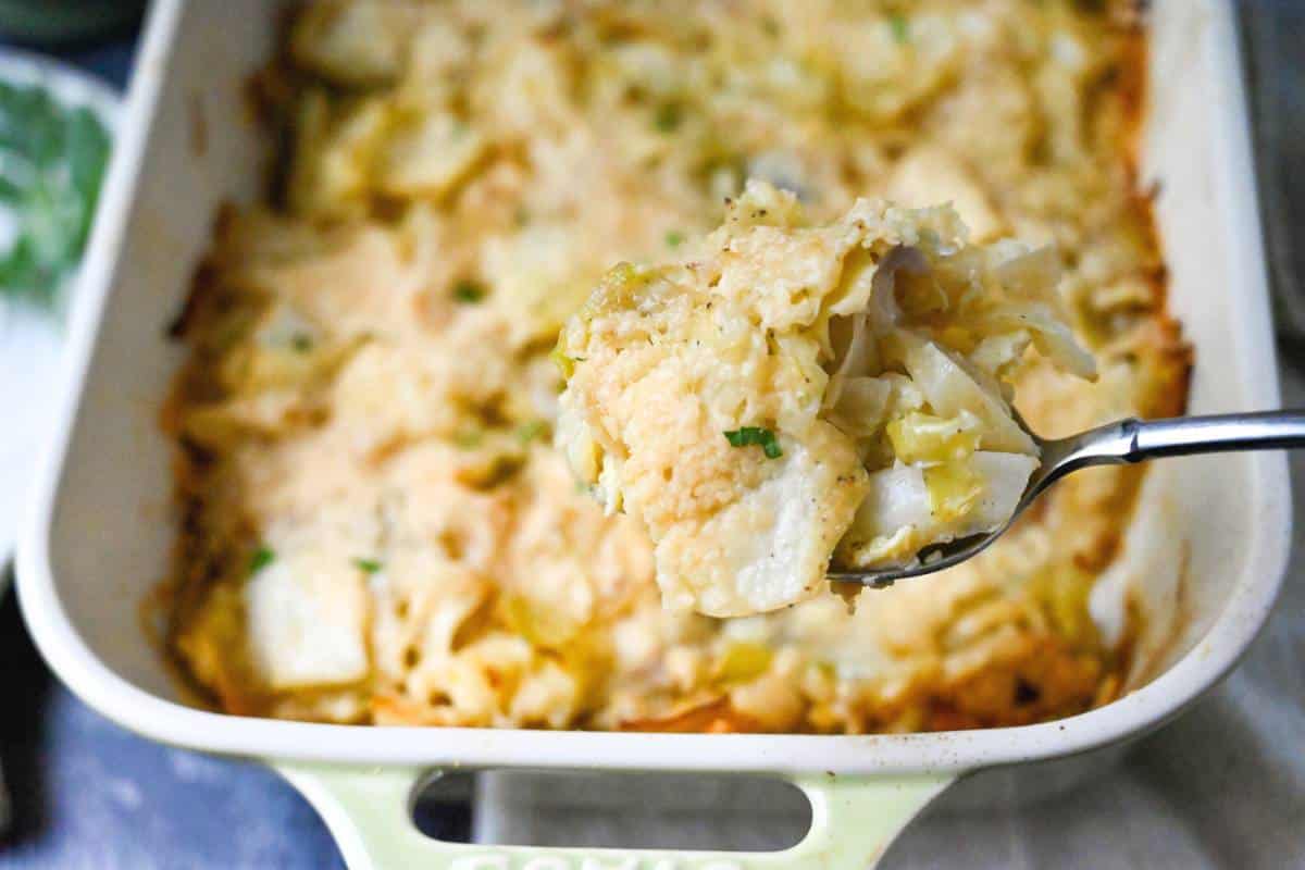 A spoonful of cabbage casserole over a baking dish