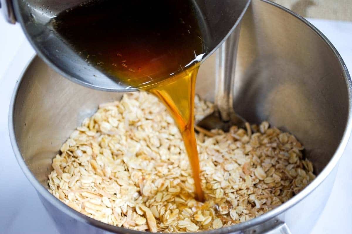 pouring the wet ingredients into the dry ingredients for homemade granola