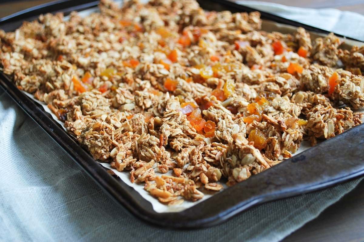 prepared vanilla almond granola on a sheet pan fresh from the oven