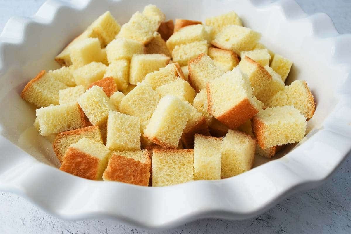 cubed brioche bread in a pie plate