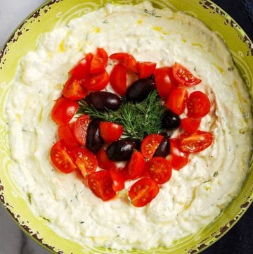 bowl of savory protein dip made with feta cheese, greek yogurt, and fresh dill
