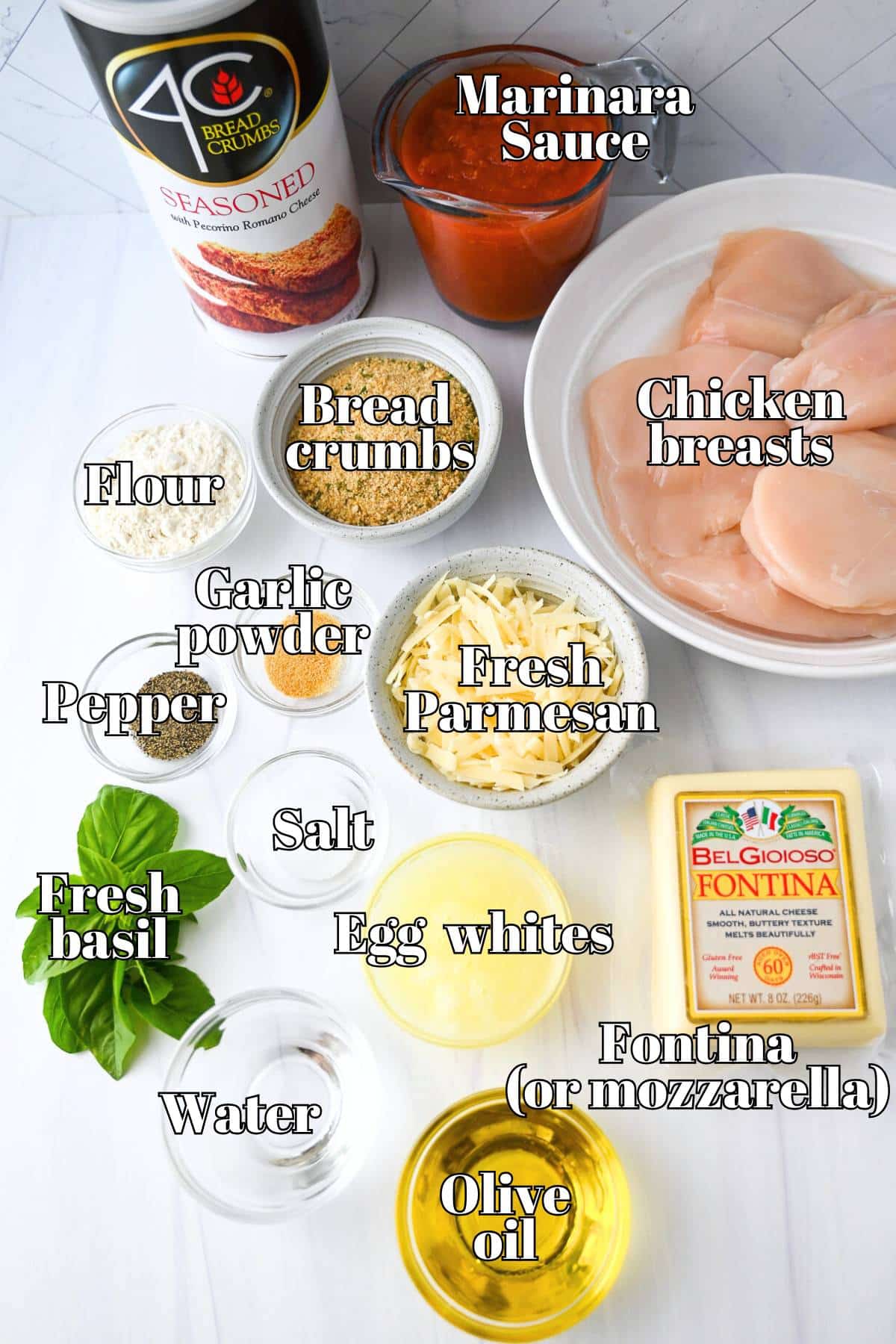 ingredients for chicken parmesan measured out on a counter