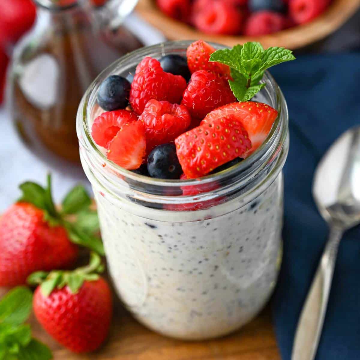 close up of a jar of overnight oats with chia seeds and berries