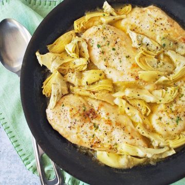 skillet of sauteed chicken with lemon and artichokes