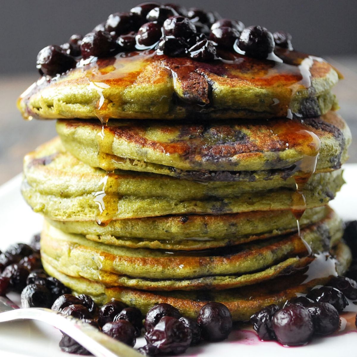 stack of matcha protein pancakes with blueberries on top