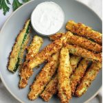 plate of air fried zucchini fries with dipping sauce