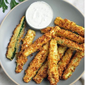 plate of air fried zucchini fries with dipping sauce