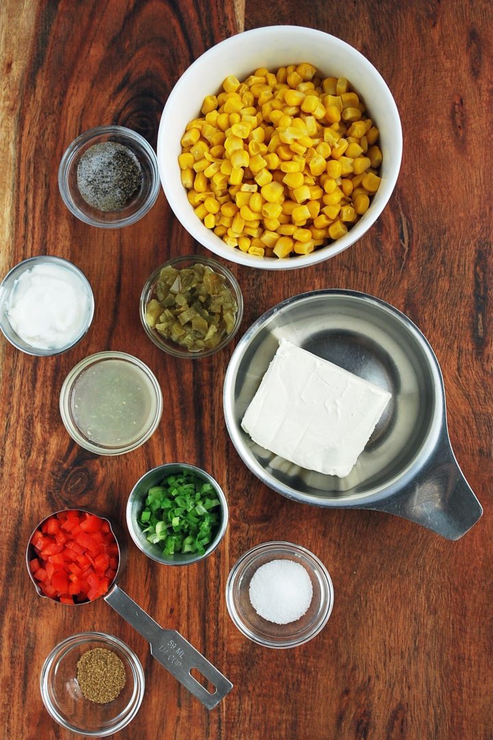 ingredients for corn relish dip on a wooden cutting board