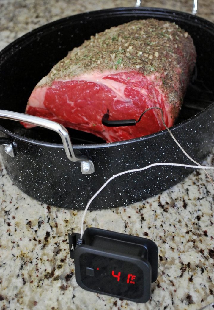meat thermometer inserted in the standing rib roast before cooking