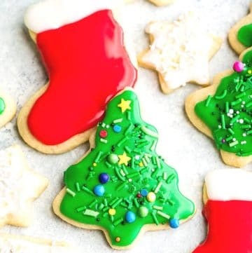 Iced Christmas tree cookie with sprinkles and Stocking christmas cookies with red and white icing