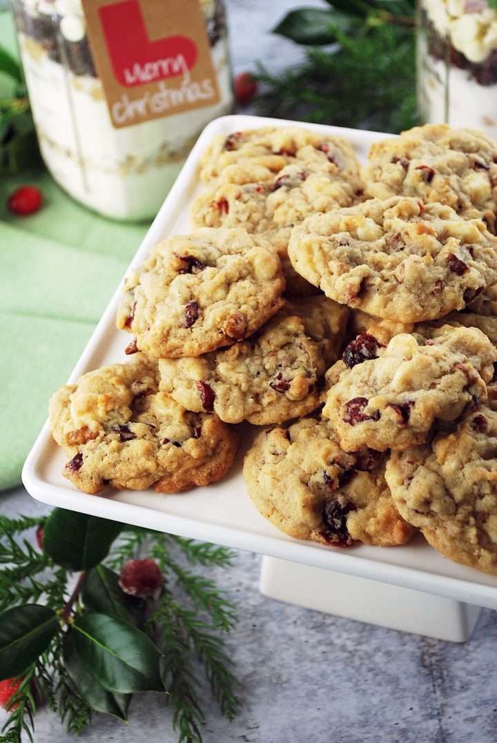 side view of cookies on a platter with layered cookie jar mix in background