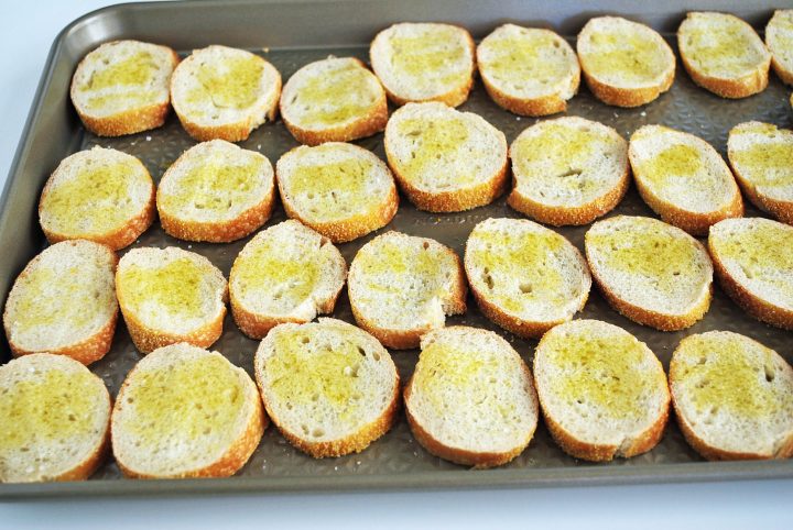 crostini on a baking sheet ready to bake