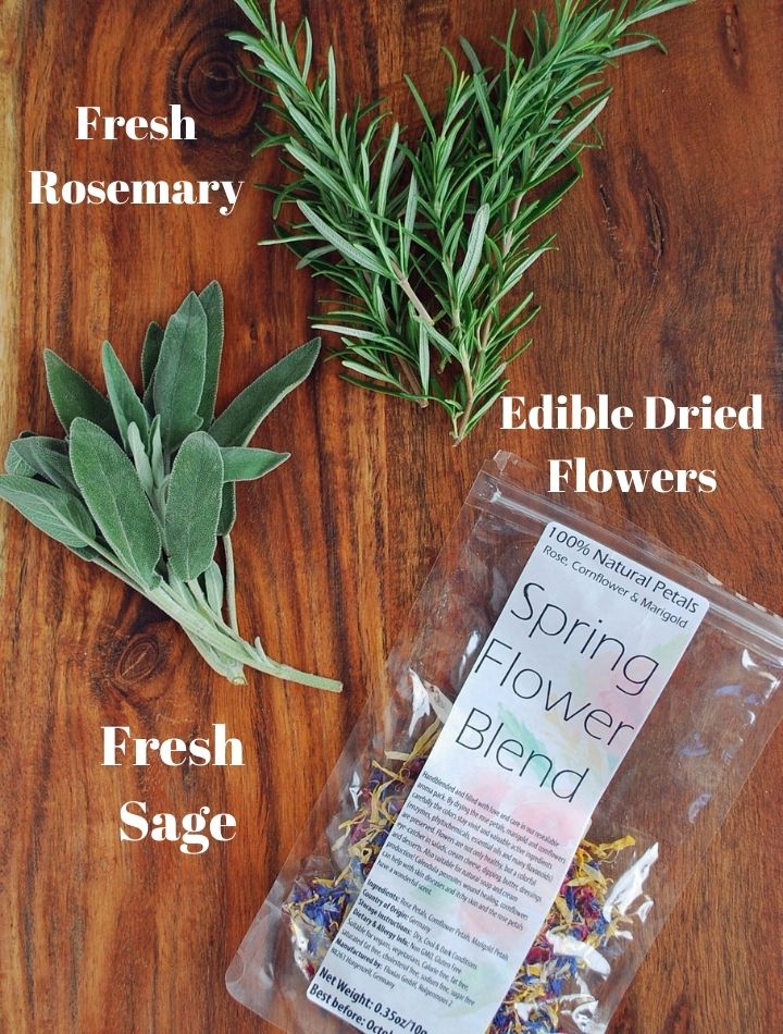 fresh herbs and dried edible flowers on a cutting board