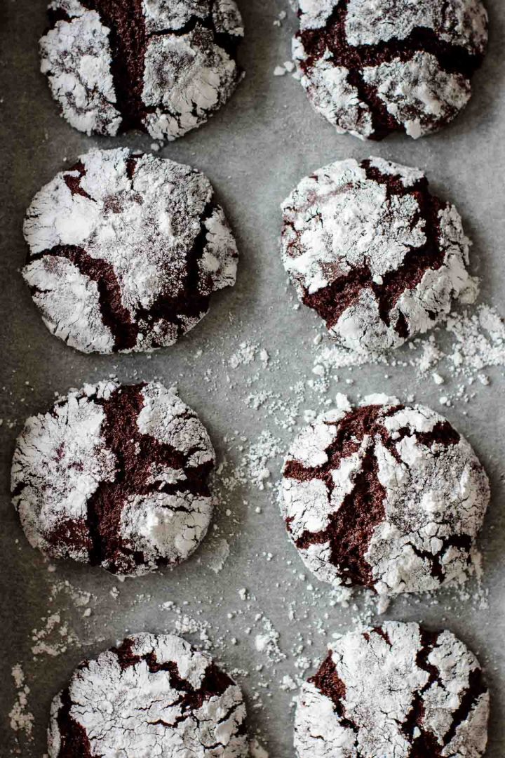 chocolate ginger crinkle cookies on parchment paper