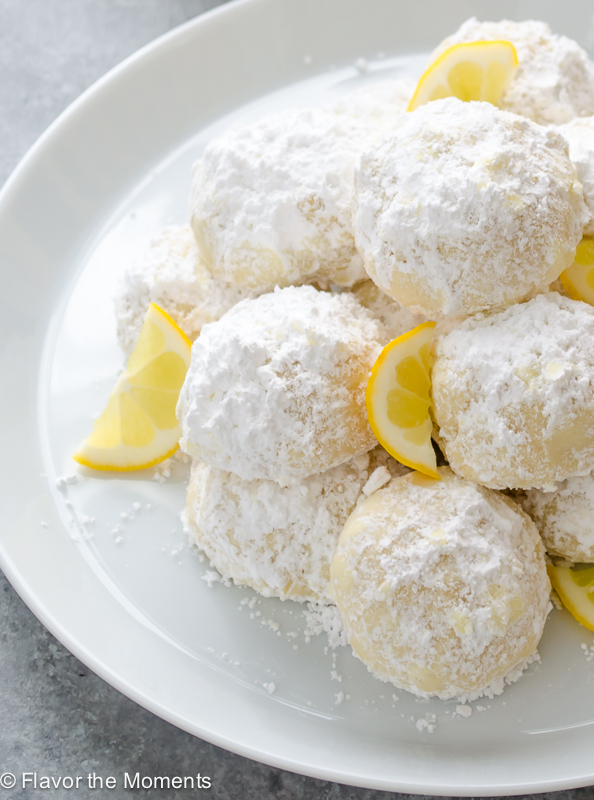 lemon cookies dusted with powdered sugar on a plate