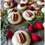 shortbread cookies with pecans on parchment paper