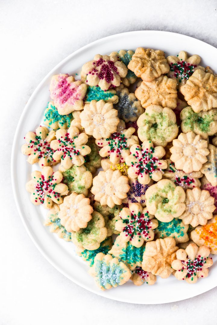 cardamom spritz cookies decorated with sprinkles on a platter