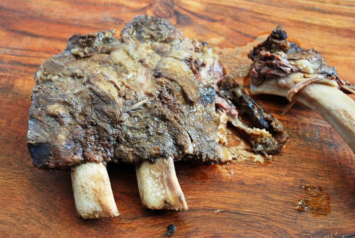 Prime rib bones cooked for soup on a cutting board