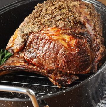 close up of a standing rib roast in a roasting pan