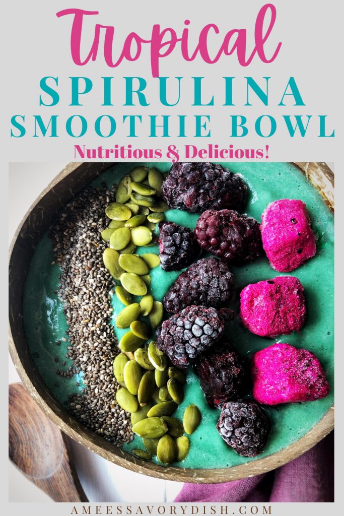 overhead photo of a blue smoothie in a bowl with a purple napkin underneath and a spoon next to the bowl.  