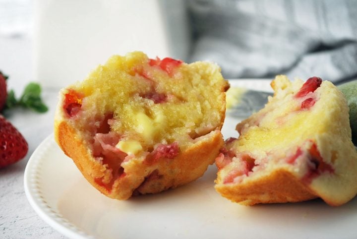close up photo of half a strawberry muffin with butter melting on top