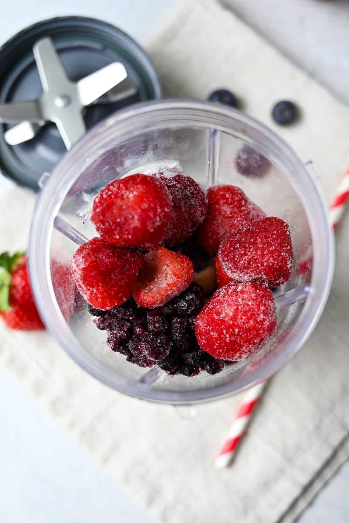 berry smoothie ingredients in a blender jar