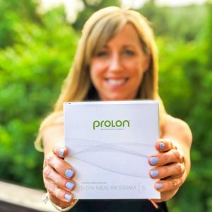 Woman holding a box of ProLon FMD