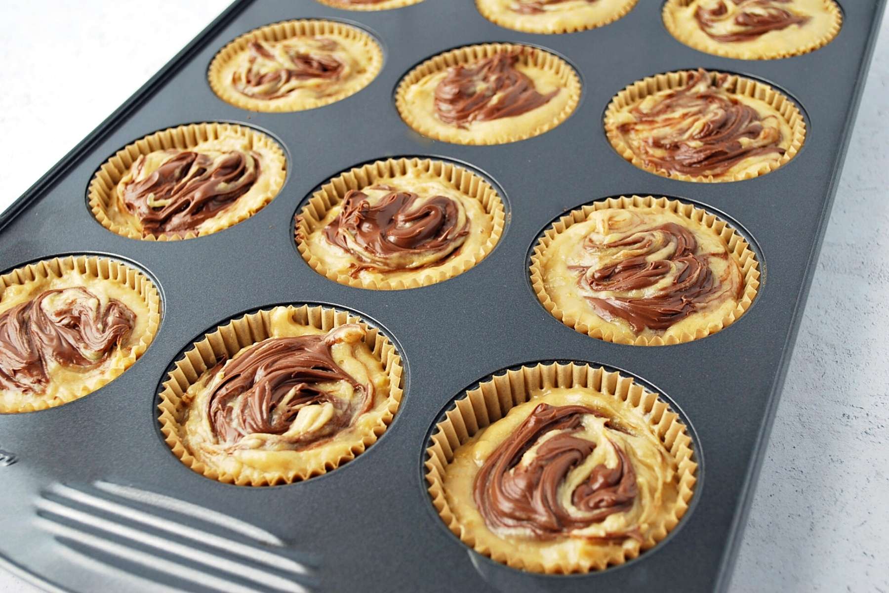 banana Nutella muffins ready to bake in a muffin pan