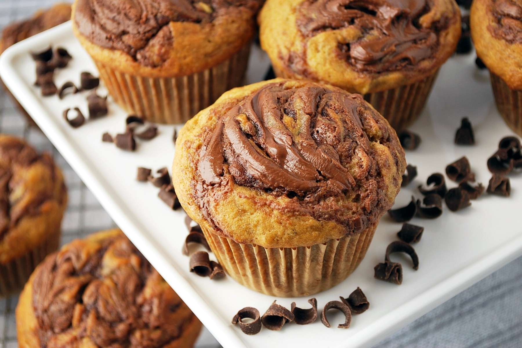 close up shot of a banana muffin with swirled Nutella on top