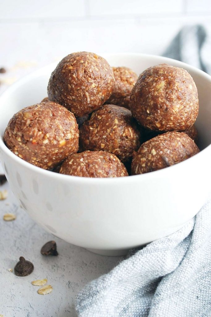 protein date balls in a bowl with a napkin around it