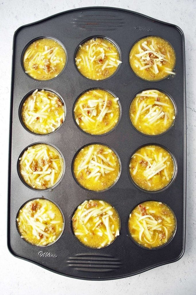 egg muffin mixture in muffin tin ready to cook