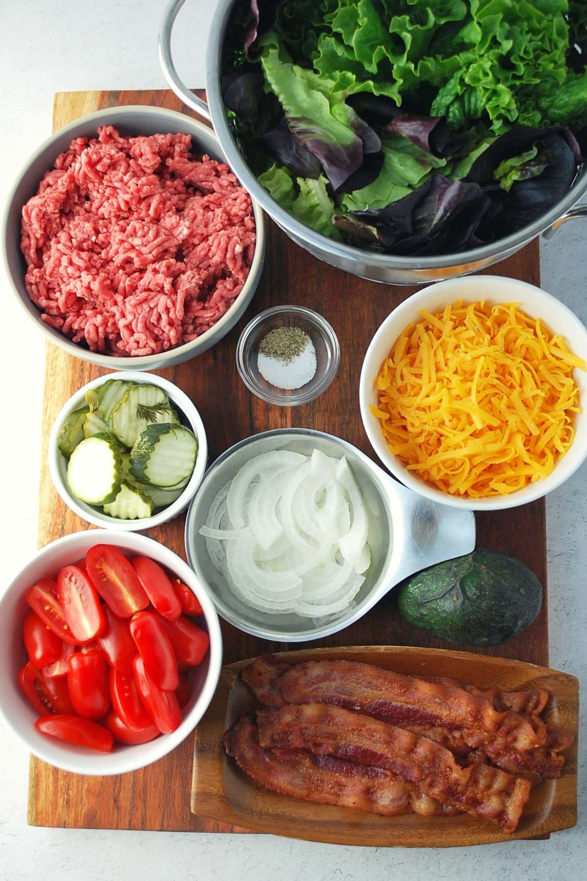 ingredients for burger bowls on a cutting board