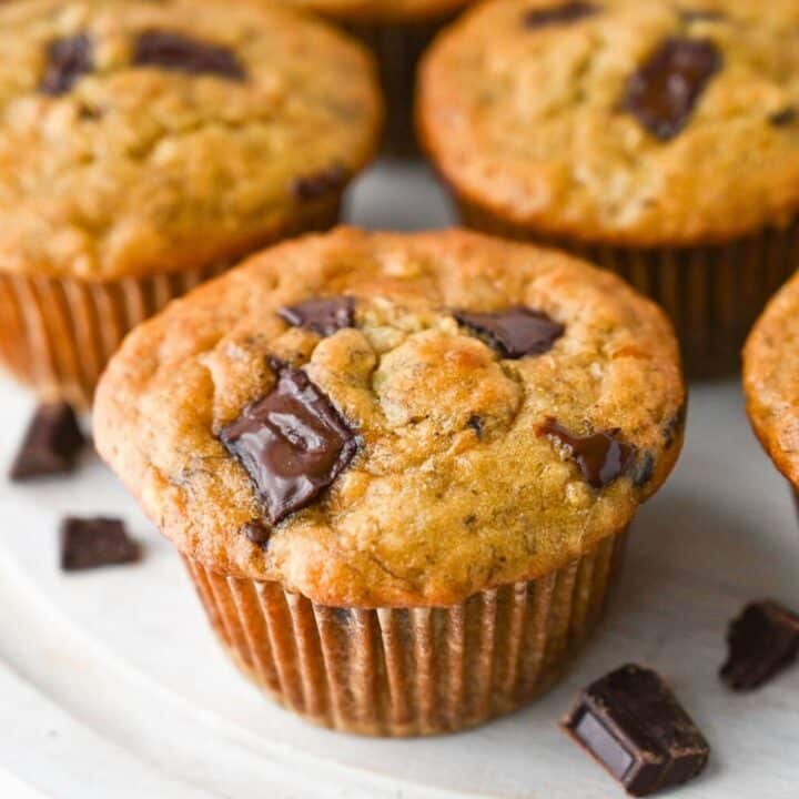 close up of a banana muffins with chunks of chocolate bar